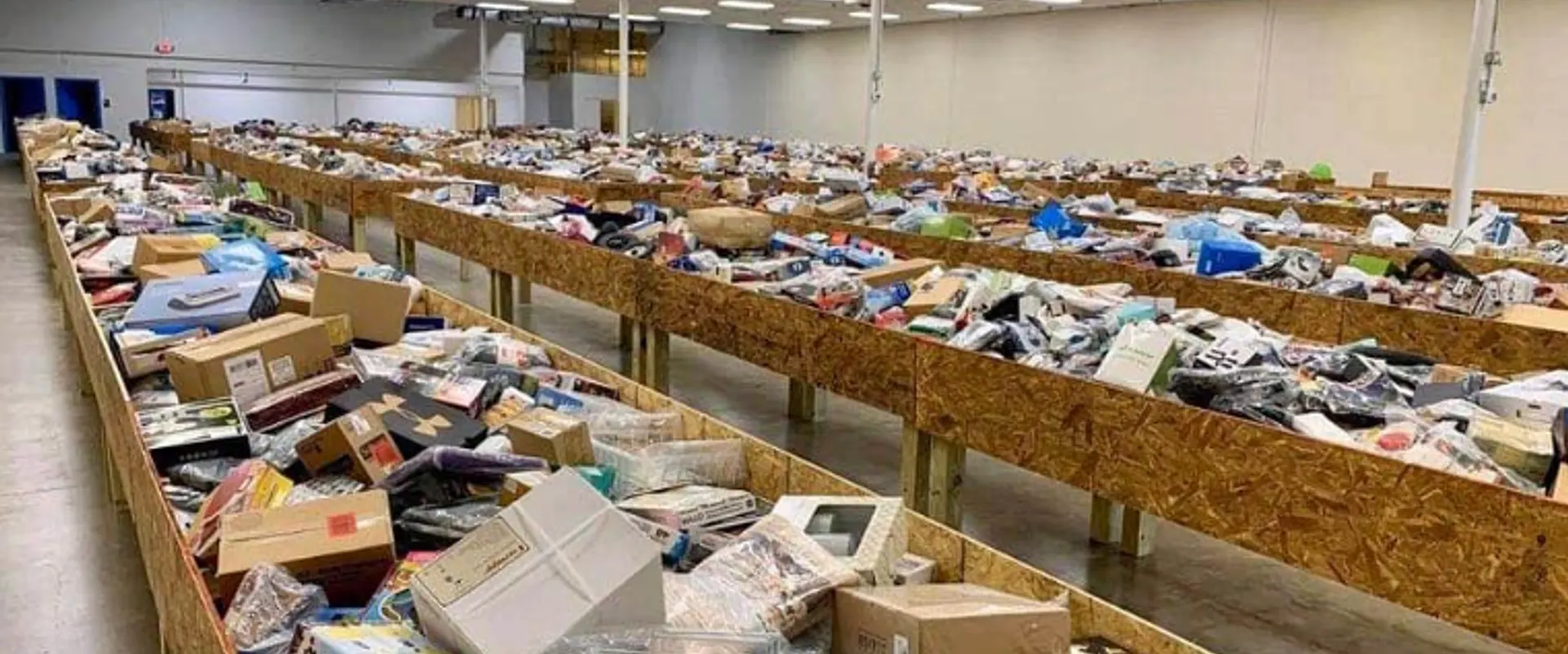 Shoppers digging through open merchandise bins at a discount bin store